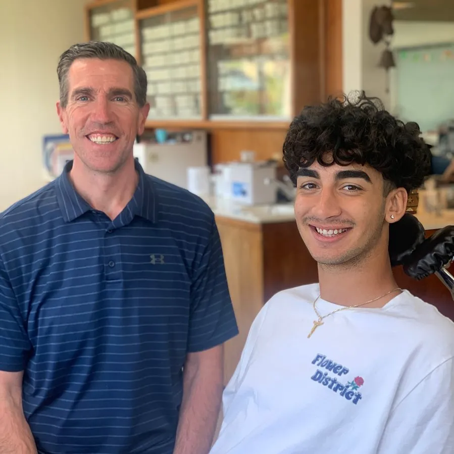 Smiling orthodontist with patient in a dental office, showcasing a supportive environment for teen Invisalign treatment at Potter Orthodontics.