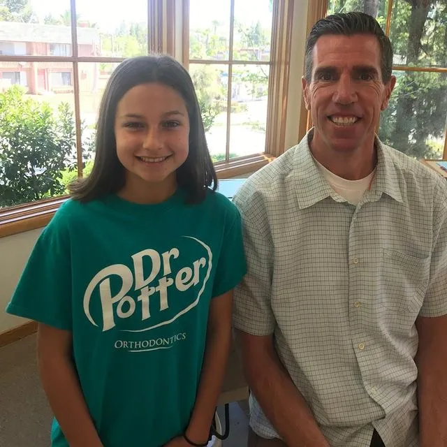 Dr. Potter and a young girl smiling