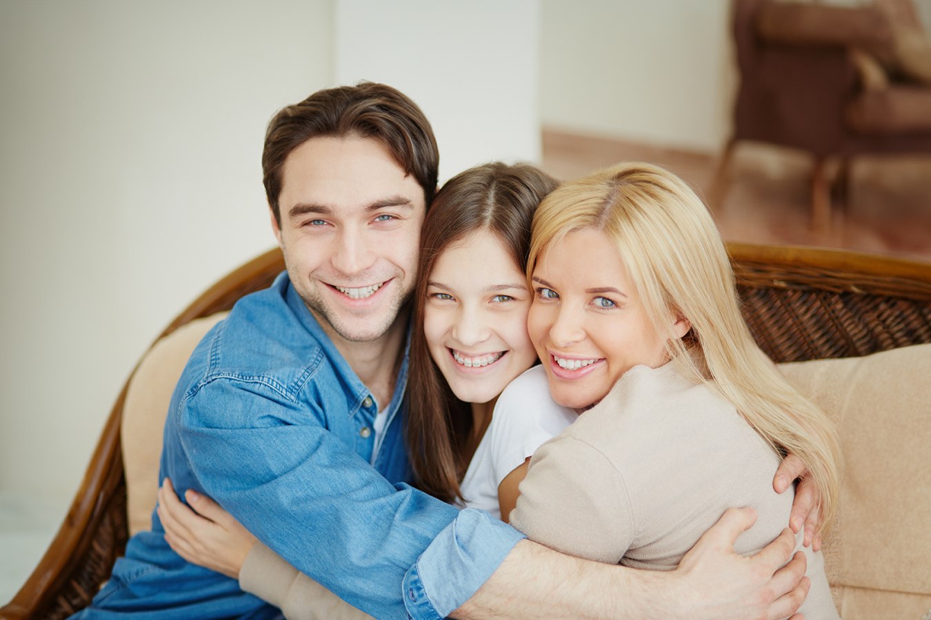 Three people hugging and smiling